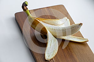 Yellow banana with peeled off skin