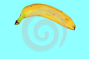 Yellow banana shape on light blue background. Banana Minimal. Pastel colors style. Popart. Digitalart. Surreal. Pop photo