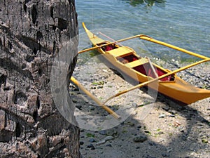 yellow banka outrigger canoe palm tree philippines