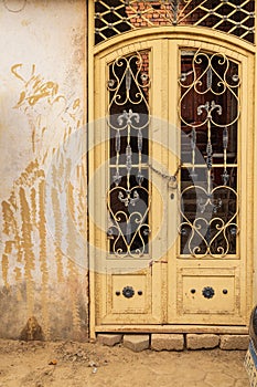 Yellow barred door in the village of Faiyum