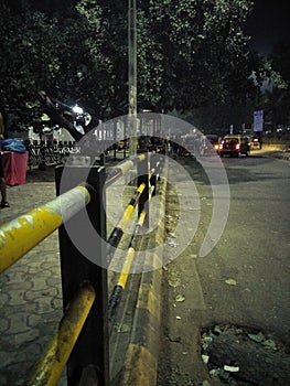 Yellow barricades and low traffic road in night