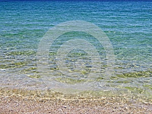 Yellow beach sand and beautiful blue sea. Natural living. Pelion peninsula. Pagasetic gulf. Platanias village. Greece.