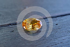 Yellow Is a beautiful red gemstone on a wooden floor