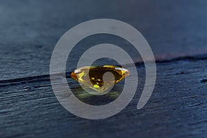 Yellow Is a beautiful red gemstone on a wooden floor