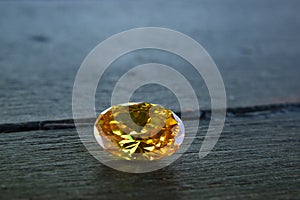 Yellow Is a beautiful red gemstone on a wooden floor