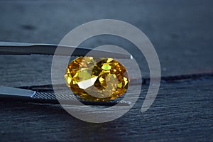 Yellow Is a beautiful red gemstone on a wooden floor