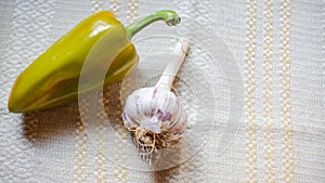 Yellow bell pepper and garlic on the white background
