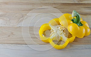 Yellow bell pepper on wooden