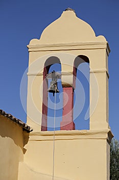 Yellow bell tower in Moraitika. Corfu. Greece.