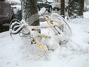 Yellow bicycle buried in the snow photo