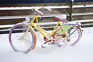 Yellow bike covered with snow