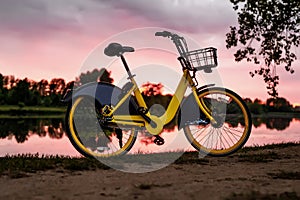 Yellow bike on the lake. Sunset