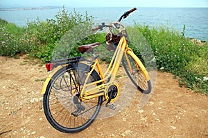 Yellow bike near the sea