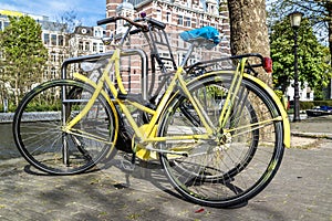 Yellow bike parked in the streets of amterdam