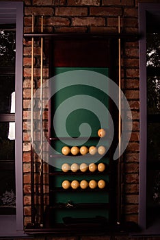 Yellow billiard balls and cue ball for billiards on the shelf,close up