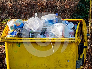 Yellow bin with plastic waste