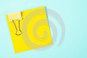 Yellow binder clips and yellow sticky notes.