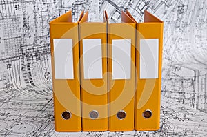 Yellow binder folders in the design drawings