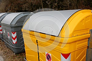 yellow bins in the recycling center of the city ecological oasis for the separate collection of waste