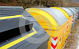 yellow bins in the recycling center of the city ecological oasis to separate collection of waste