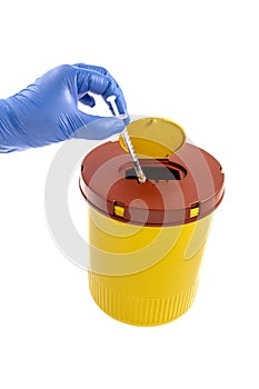 Yellow biohazard medical contaminated sharps clinical waste container isolated on white background