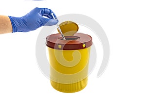 Yellow biohazard medical contaminated sharps clinical waste container isolated on white background