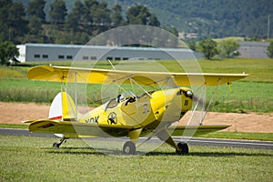 Yellow biplane at air show Aerosport