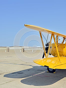 Yellow biplane at airfield