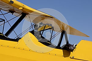 Yellow Biplane Cockpit with Flight Goggles and Bomber Jacket