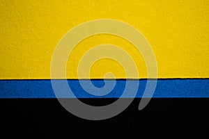 Yellow and black background divided horizontally with blue stripe