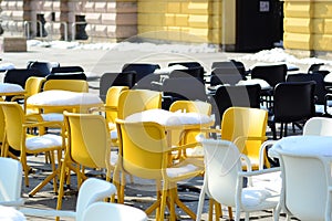Yellow and black chairs covered in snow