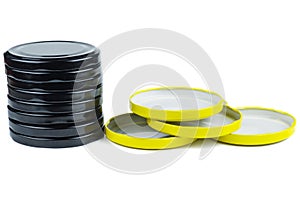 Yellow and black metal jar lids isolated on white background