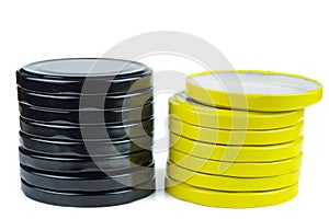 Yellow and black metal jar lids isolated on white background