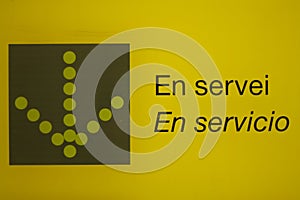 Yellow black sign in service en servicio photo