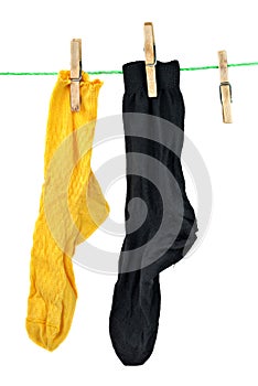Yellow and black socks hanging on rope photo