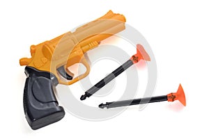 A yellow black spring suction cup dart toy pistol gun against a white backdrop