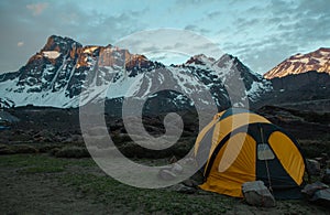 Tent in the mountain during the sunrise photo