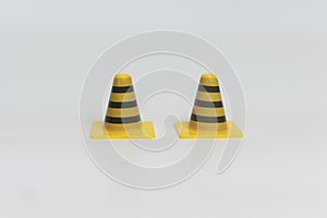 Yellow and black toy traffic cone isolated on white background