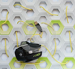 Yellow and black USB mouse on white and green honeycomb background