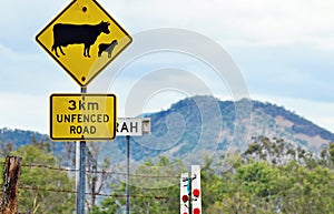 Warning road sign cattle sheep crossing in rural countryside