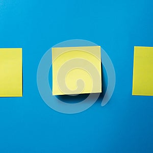 Yellow Blank Sticky Note on Blue Wall