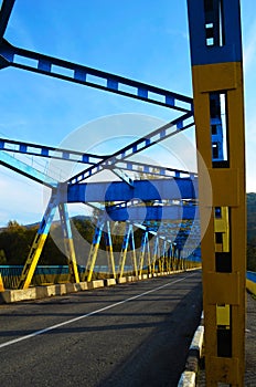 Yellow and blue bridge with clear blue sky