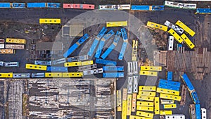Yellow and blue buses and cars aerial top view.  abandoned transport parking.