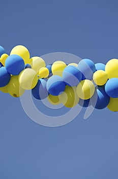 Yellow blue color balloons on background blue sky