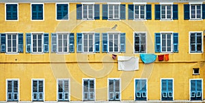 Yellow and blue facade with laundry in Bastia Corsica