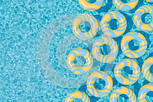 Yellow and Blue Inflatable Rings Floating in Swimming Pool