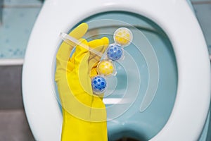 A yellow-blue plastic toilet block that cleans the walls of the toilet and refreshes the bathroom.