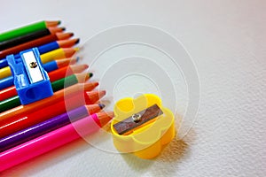 Yellow ,blue sharpeners on color pencils isolate on white bakground
