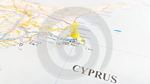 A yellow board pin stuck in Ayia Napa on a map of Cyprus