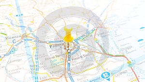 A yellow board pin stuck in Padova on a map of Italy photo